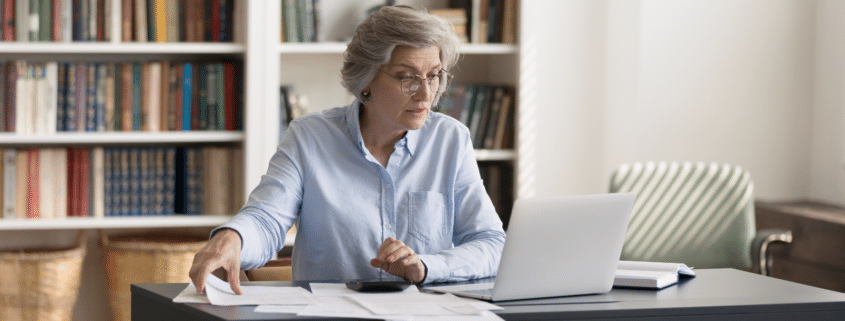 A woman reviewing and calculating taxes