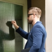 An IRS officer knocking on the door of a homeowner for a visit