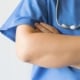 A close-up of the folded arms of a medical professional